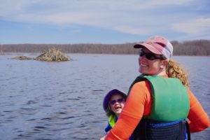 Mom and daughter kayaking in river with beaver lodge in Missisquoi Wildlife Refuge Vermont