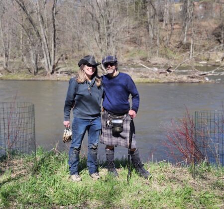 Tow standing next to planted trees in Green-River Meadows after a Tree Planting Volunteer event