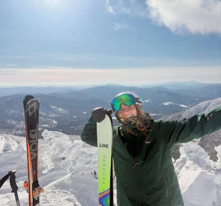 UVM Intern Sarah with skis on mountain 