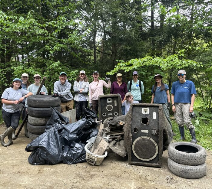 VHCB AmeriCorps members and staff next to trash they picked at at Kingsbury Branch River clean up
