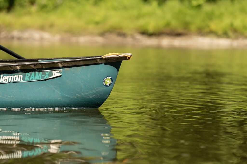 Canoe with a Vermont River Conservancy sticker "Find Your River" on free flowing river