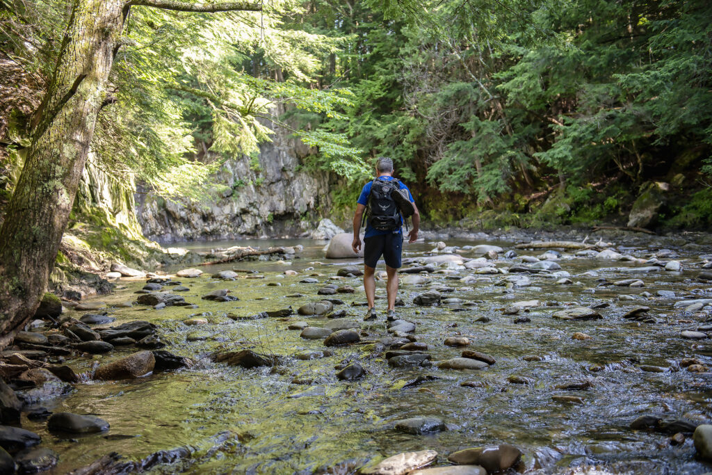 Guy standing in Swimming Hole in Vermont by Jay Ericson