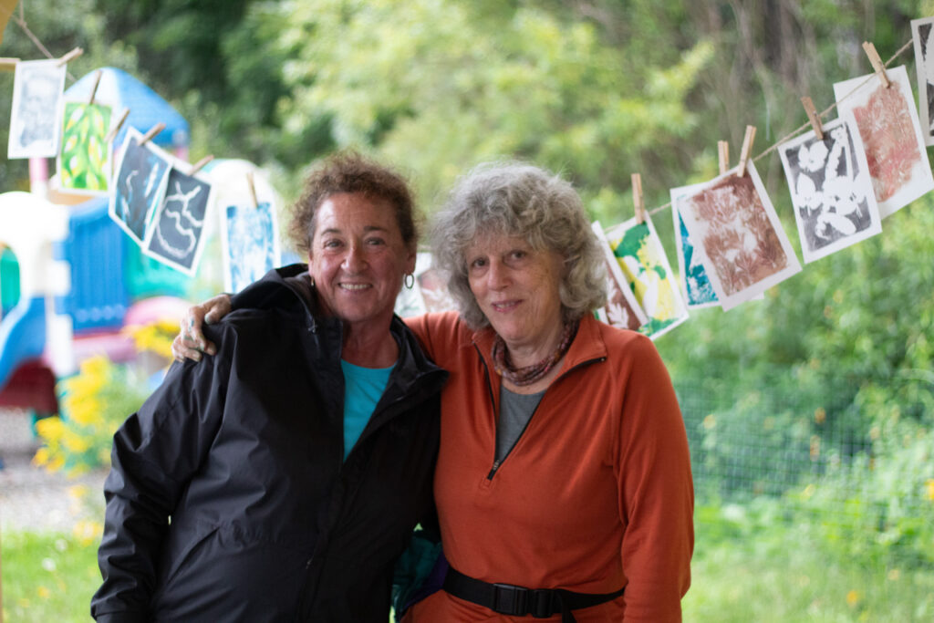 Smiling participants enjoying the community monoprinting Vermont River Conservancy river tour art event in Johnson, Vermont.